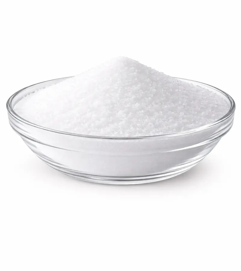 Fine white granulated table salt mounded in a clear glass bowl